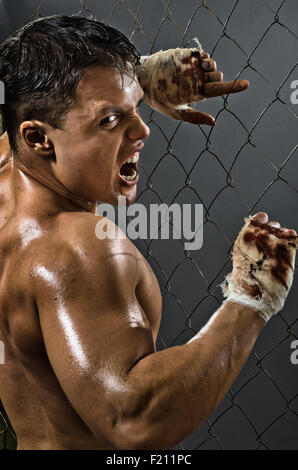 vertical photo  muscular young  guy street-fighter,  aggression awesome yell , hard light Stock Photo