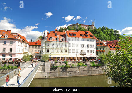 Ljubljana, Slovenia - September 7, 2015 - Bridge on Ljubljanica river and Ljubljana's castle in the background Stock Photo