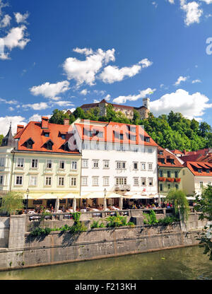 Ljubljana, Slovenia - September 7, 2015 - Bridge on Ljubljanica river and Ljubljana's castle in the background Stock Photo