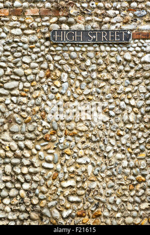 High Street sign on a typical flint built wall in Blakeney, North Norfolk, England UK Stock Photo