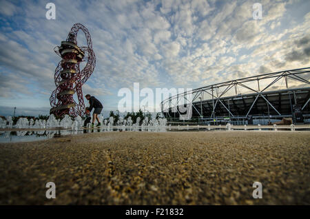 Queen Elizabeth Olympic Park, London, UK stadium, tower and fountain. Built for London 2012 Olympics. Venue. Father & child playing in fountains Stock Photo