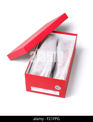 Open Box With Shoes in Protective Bags on White Background Stock Photo