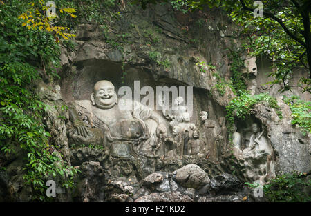 Buddha carved into rock face of Feilai Feng hill at Lingyin Temple, oldest Buddhist temple in China Stock Photo