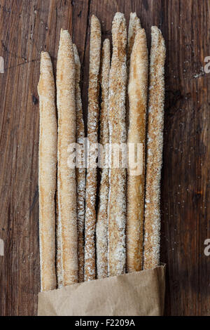 Rustic italian  bread sticks on wooden background. Stock Photo