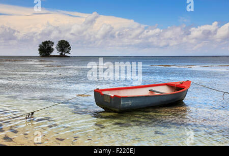 Boat in shallow sea on Seychelles. Stock Photo