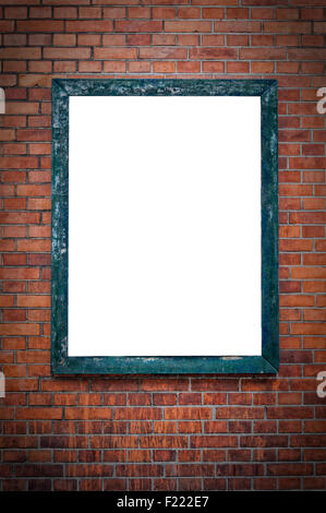 A blank billboard under a spotlight and hanging on a brick wall. Stock Photo
