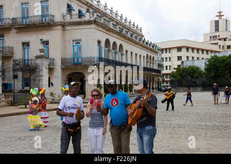 Busking on Plaza de Armas with Tourist in Havana - Cuba Stock Photo