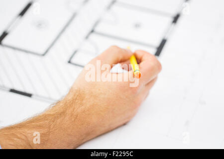 close up of male hand with blueprint and pencil Stock Photo