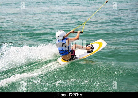 A young wakeboarder in action on the lake Stock Photo