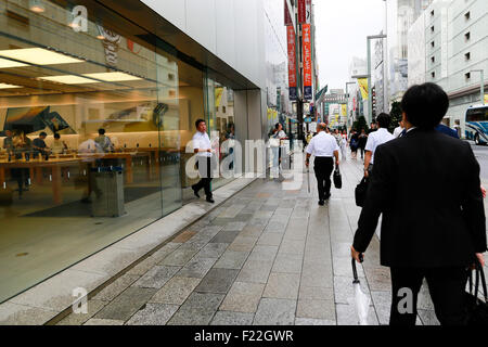Pedestrians walk past the Apple Store in Ginza on September 10, 2015, Tokyo, Japan. Even after Apple CEO Tim Cook announced their new products iPad Pro, iPhone 6s, iPhone 6s Plus and Apple TV on September 9, 2015, hardcore Japanese fans were nowhere to be seen outside the principal stores in Ginza and Omotesando. This could be because of heavy rain that hit Japan this week caused by typhoon Etau, or perhaps Apple fans are now less excited by this clockwork new release cycle. In Australia the media already reported that the first Apple fan had set up a tent in front of the store in Sydney. (Pho Stock Photo