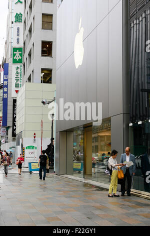 Pedestrians walk past the Apple Store in Ginza on September 10, 2015, Tokyo, Japan. Even after Apple CEO Tim Cook announced their new products iPad Pro, iPhone 6s, iPhone 6s Plus and Apple TV on September 9, 2015, hardcore Japanese fans were nowhere to be seen outside the principal stores in Ginza and Omotesando. This could be because of heavy rain that hit Japan this week caused by typhoon Etau, or perhaps Apple fans are now less excited by this clockwork new release cycle. In Australia the media already reported that the first Apple fan had set up a tent in front of the store in Sydney. (Pho Stock Photo