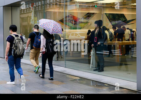 Pedestrians walk past the Apple Store in Ginza on September 10, 2015, Tokyo, Japan. Even after Apple CEO Tim Cook announced their new products iPad Pro, iPhone 6s, iPhone 6s Plus and Apple TV on September 9, 2015, hardcore Japanese fans were nowhere to be seen outside the principal stores in Ginza and Omotesando. This could be because of heavy rain that hit Japan this week caused by typhoon Etau, or perhaps Apple fans are now less excited by this clockwork new release cycle. In Australia the media already reported that the first Apple fan had set up a tent in front of the store in Sydney. (Pho Stock Photo