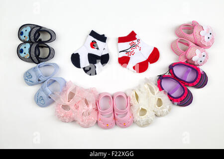 Children's shoes and socks laid semicircle on a light background. Stock Photo
