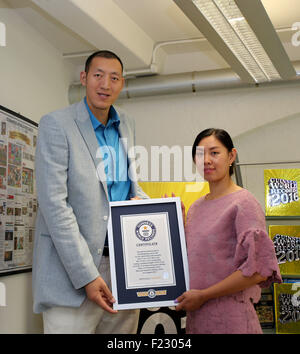London, UK. 10th September, 2015. China's Sun Mingming and his wife Xu Yan pose for a photo during their visit at the Guinness World Records headquarters in London, Britain, on Sept. 10, 2015. With a combined height of 423.47cm, Sun Mingming and his wife Xu Yan claim the title for the world's tallest married couple. Credit:  Xinhua/Alamy Live News Stock Photo