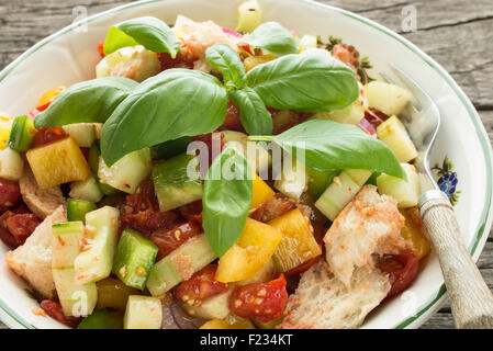 Salad with ciabatta bread, pepper, cucumber, tomatoes and basil Stock Photo