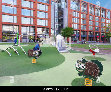 The childrens playgound with the shops behind in Piccadilly Gardens, Manchester, UK.