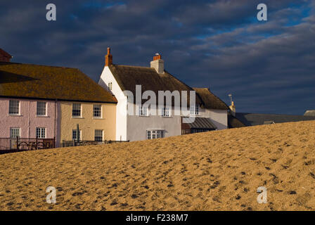 Beach front cottages on East Beach at West Bay near Bridport on Dorset's Jurassic Coast, England, UK Stock Photo