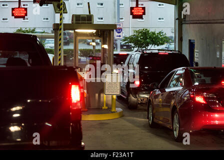 Cars wait to pay fee at a parking garage exit. Stock Photo