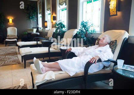 Senior woman relaxing in lounge chair at the spa in French Lick Resort, Indiana, USA Stock Photo