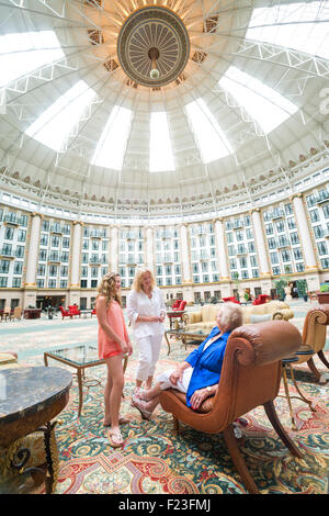 Caucasian multi-generational family converse in the domed six story atrium at West Baden Springs Resort, French Lick, Indiana Stock Photo