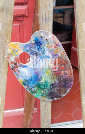 Painting palette hanging in the street on a easel, tripod Stock Photo