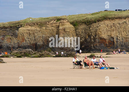 Holidaymakers relaxing in the summer sun on Gwithian sands beach, Cornwall, England Stock Photo