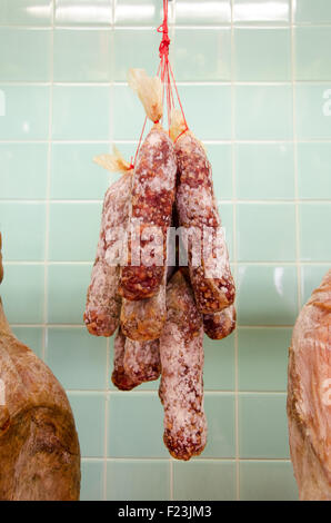 Saucisson ham jamon drying, hanging at the ceiling Stock Photo