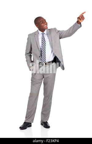 cheerful African businessman pointing at empty copy space Stock Photo