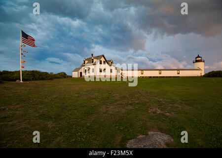 Goat Island Lighthouse bathed in evening light with storm clouds blowing over Stock Photo
