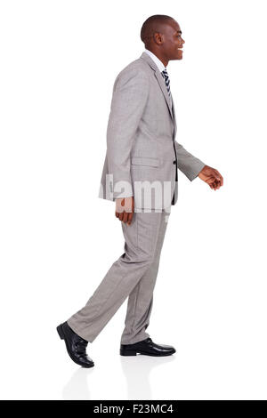 side view of young African American businessman walking Stock Photo