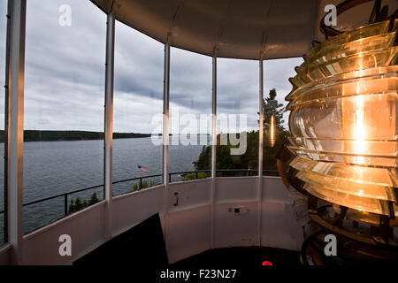 Fourth Order Fresnel Lens lit up inside the Owls Head Light Station in Owls Head Maine Stock Photo