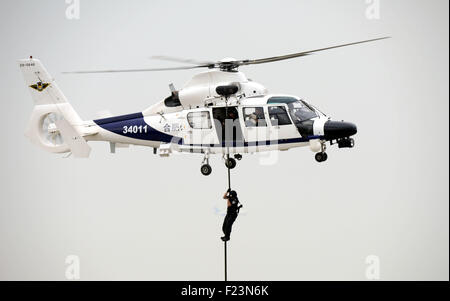 Tianjin, China. 9th Sep, 2015. An AC312 helicopter transports a SWAT member during a performance at the Tianjin International Helicopter Exhibition in a helicopter base of Aviation Industry Corporation of China in the Airport Area of China Pilot Free Trade Zone of Tianjin, north China, north China, Sept. 9, 2015. The exhibition displayed 56 helicopters and attracted 366 enterprises. © Liu Yang/Xinhua/Alamy Live News Stock Photo