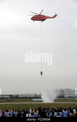 Tianjin, China. 9th Sep, 2015. An AC313 helicopter casts 5-ton water to extinguish fire during a performance at the Tianjin International Helicopter Exhibition in a helicopter base of Aviation Industry Corporation of China in the Airport Area of China Pilot Free Trade Zone of Tianjin, north China, north China, Sept. 9, 2015. The exhibition displayed 56 helicopters and attracted 366 enterprises. © Liu Yang/Xinhua/Alamy Live News Stock Photo