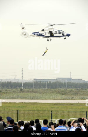 Tianjin, China. 9th Sep, 2015. An AC312 helicopter transports an 'injured person' during a performance at the Tianjin International Helicopter Exhibition in a helicopter base of Aviation Industry Corporation of China in the Airport Area of China Pilot Free Trade Zone of Tianjin, north China, north China, Sept. 9, 2015. The exhibition displayed 56 helicopters and attracted 366 enterprises. © Liu Yang/Xinhua/Alamy Live News Stock Photo