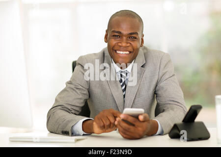 professional young African businessman using smart phone in office Stock Photo