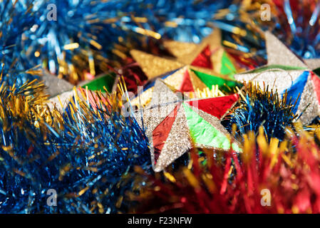 Christmas decoration stars in multicolored tinsel. Holiday decoration. Stock Photo