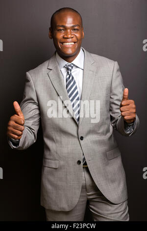 happy young African American man giving thumbs up on white background Stock Photo