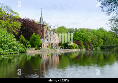 Flemish style building reflecting in Minnewater lake, Fairytale scenery in Bruges, Belgium Stock Photo