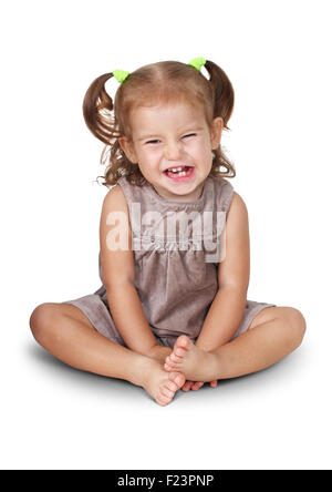 Sitting angry child girl with grin isolated on white Stock Photo