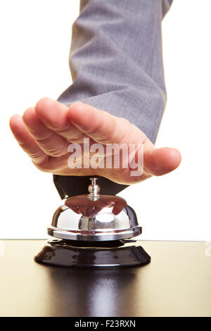 Hand over a hotel bell on a counter Stock Photo