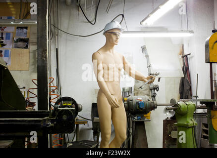 A mannequin in a machine shop Stock Photo