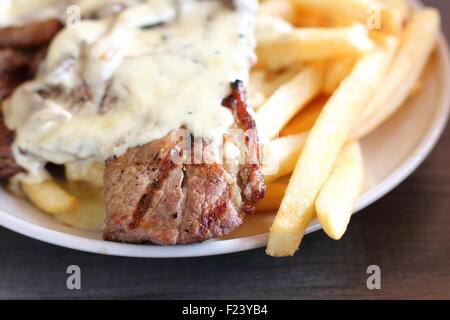 Steak and Chips with Creamy mushroom sauce Stock Photo