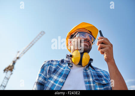 builder in hardhat with walkie talkie Stock Photo