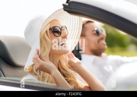 happy man and woman driving in cabriolet car Stock Photo