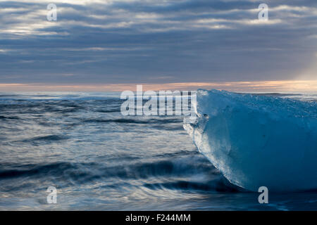 Icebergs from the Jokulsarlon glacial lagoon washed up on a black volcanic sand beach. South Iceland. Stock Photo