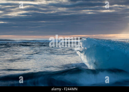 Icebergs from the Jokulsarlon glacial lagoon washed up on a black volcanic sand beach. South Iceland. Stock Photo