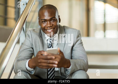 happy young African American man using mobile phone Stock Photo