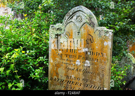 Grave stones in the churchyard of the famous St Just in Roseland church in Cornwall, UK. Stock Photo