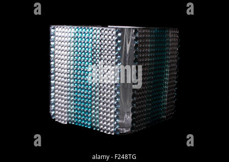 A tissue holder box studded with gems and glass beads, isolated on black background. Stock Photo