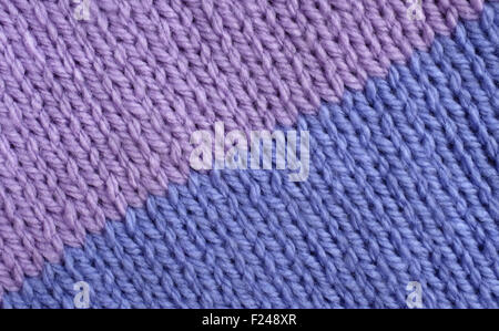 Two colour stocking stitch knitting in lilac and blue as an abstract background texture Stock Photo
